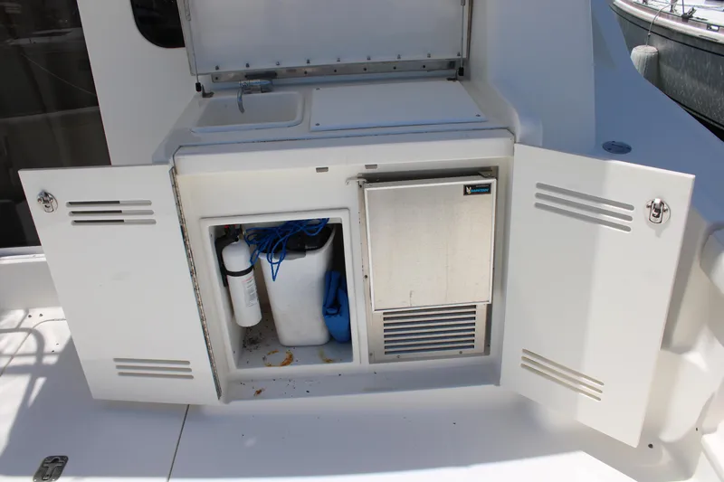 Slide: The Image of 2006 Silverton 42 Convertible yacht storage compartment with open doors and visible equipment. - 7