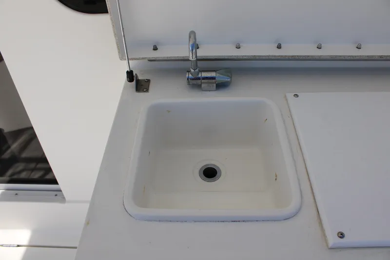 Slide: The Image of White sink and faucet on 2006 Silverton 42 Convertible yacht. - 9