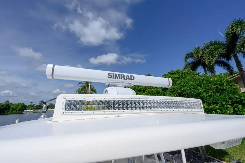 Slide: The Image of Simrad radar on 2021 SeaVee 370z boat, clear sky, palm trees in background. - 10
