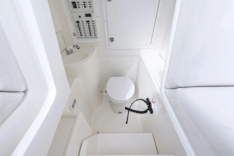 Slide: The Image of 2021 SeaVee 370z boat interior bathroom with toilet and control panel. - 13