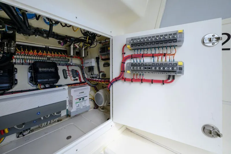 Slide: The Image of Electrical panel inside 2021 SeaVee 370z boat, showcasing wiring and components. - 14