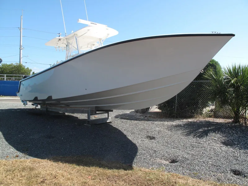 Slide: The Image of 2021 SeaVee 370z boat on trailer, parked outdoors under clear blue sky. - 18