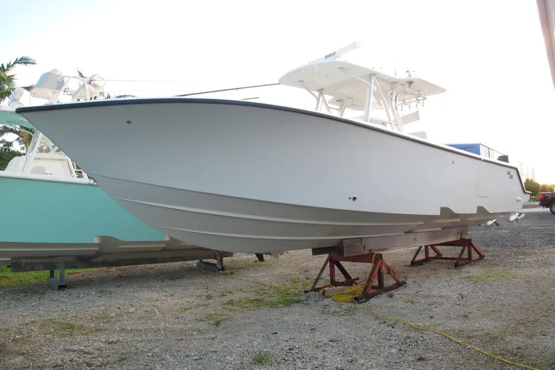 Slide: The Image of 2021 SeaVee 370z boat on stands, side view, outdoors. - 26