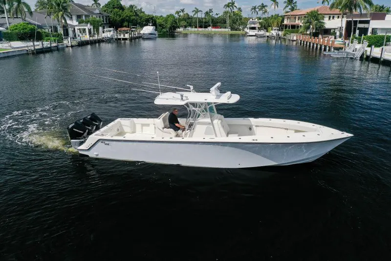 Slide: The Image of 2021 SeaVee 370z boat cruising in a scenic waterfront neighborhood. - 3