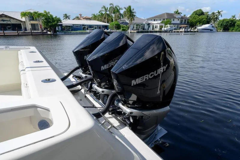 Slide: The Image of 2021 SeaVee 370z boat with triple Mercury outboard engines on a calm waterfront. - 5