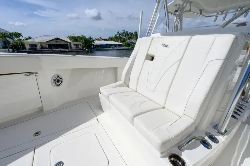 Slide: The Image of Luxurious seating on 2021 SeaVee 370z boat, featuring sleek white upholstery and waterfront view. - 7