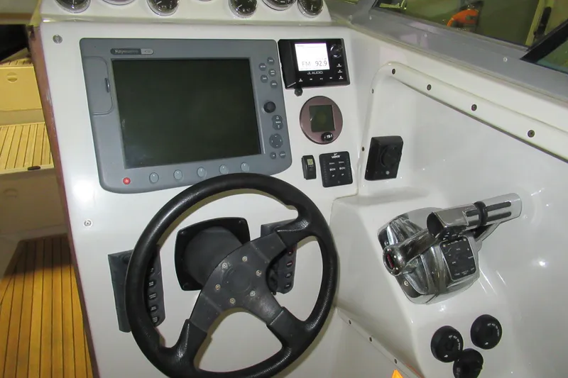 Slide: The Image of 2007 Protector Targa 28 boat dashboard with steering wheel and navigation controls. - 3