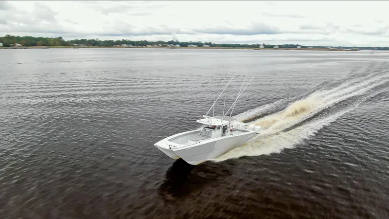 Slide: The Image of Freeman 42LR 2020 boat cruising on open water, creating a wake. - 3