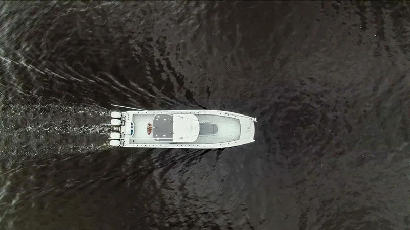 Slide: The Image of Aerial view of 2020 Freeman 42LR boat cruising on dark water. - 5