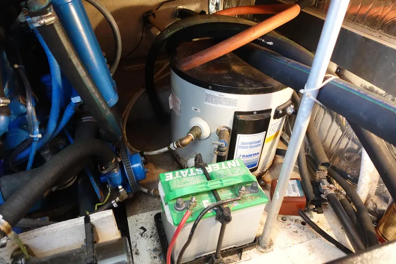 Slide: The Image of Engine room of a 1988 Trojan 10.8 Meter Sedan with battery and water heater. - 17