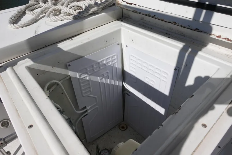 Slide: The Image of Open storage compartment on 1988 Trojan 10.8 Meter Sedan boat deck. - 18