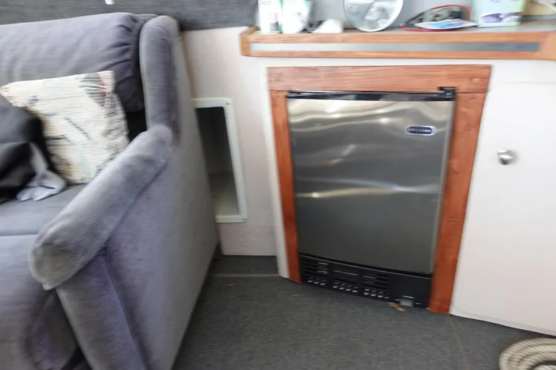 Slide: The Image of Interior of 1988 Trojan 10.8 Meter Sedan with mini fridge and sofa. - 21