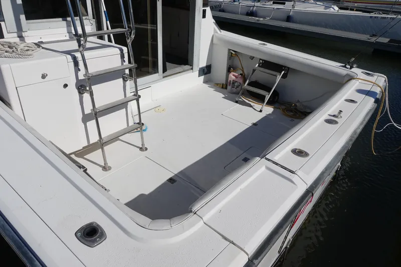 Slide: The Image of 1988 Trojan 10.8 Meter Sedan boat deck with ladder and storage compartments. - 12