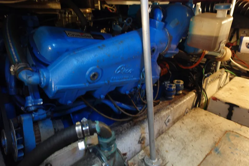 Slide: The Image of Engine compartment of a 1988 Trojan 10.8 Meter Sedan boat, featuring a blue engine. - 15