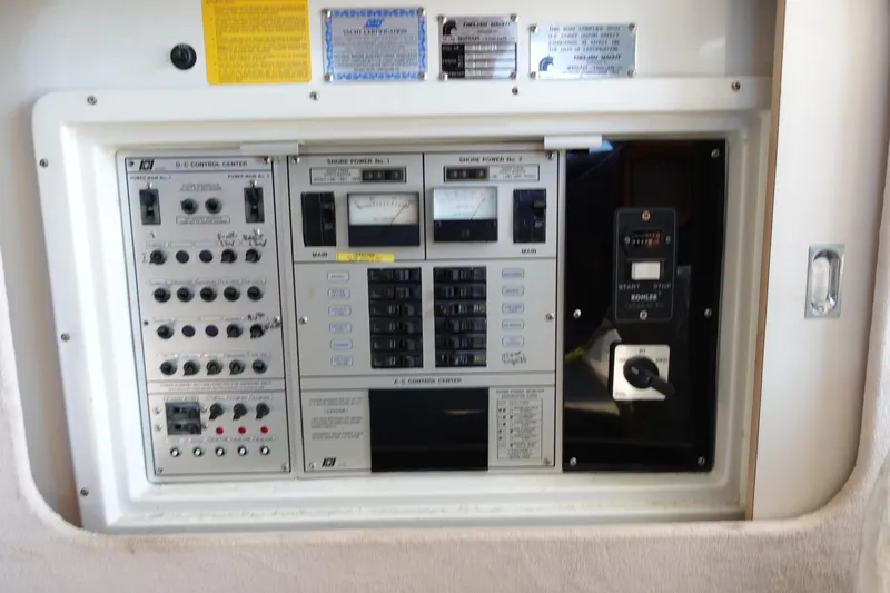 Slide: The Image of Control panel of a 1988 Trojan 10.8 Meter Sedan boat with various switches and gauges. - 20