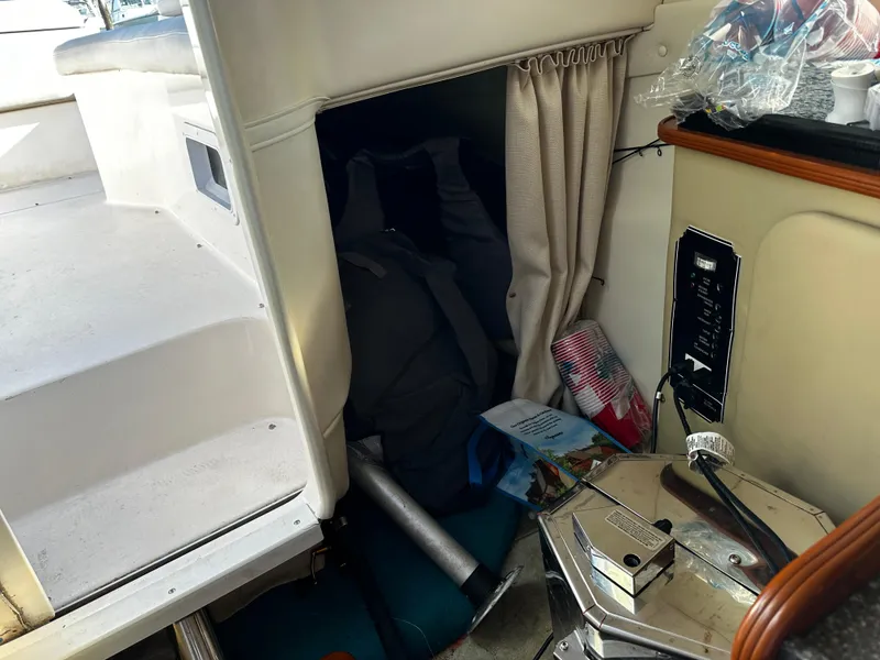 Slide: The Image of 2004 Rinker Fiesta Vee 250 cabin interior with storage area and boating equipment. - 11