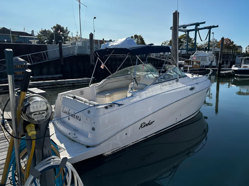 Slide: The Image of 2004 Rinker Fiesta Vee 250 boat docked at marina, clear day, calm water. - 18