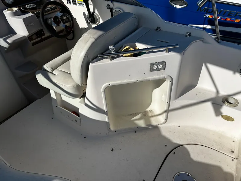 Slide: The Image of 2004 Rinker Fiesta Vee 250 boat interior with seating and control panel. - 4