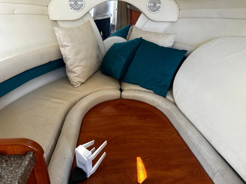 Slide: The Image of 2004 Rinker Fiesta Vee 250 cabin interior with cozy seating and cushions. - 8