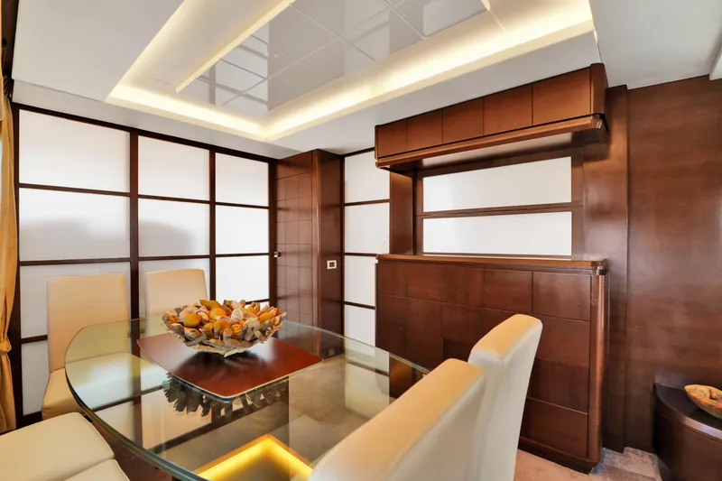 Slide: The Image of Luxurious dining area on 2009 Azimut 75 yacht with elegant wood paneling and modern decor. - 19