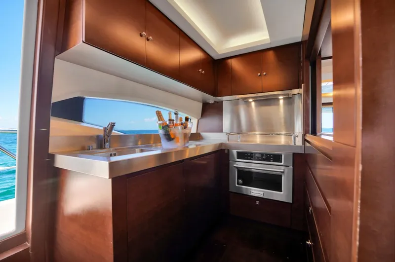 Slide: The Image of Luxurious kitchen interior of 2009 Azimut 75 yacht with modern appliances and wood cabinetry. - 23
