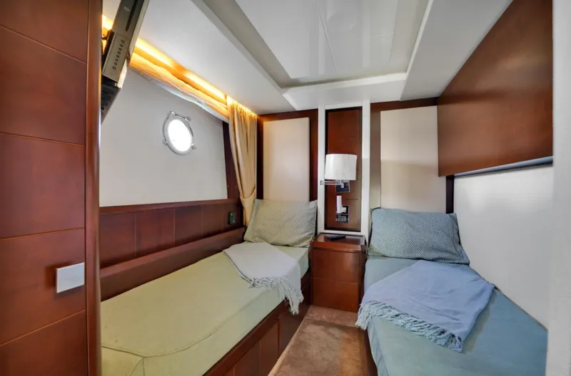 Slide: The Image of Luxurious 2009 Azimut 75 yacht cabin with twin beds and elegant wood paneling. - 36