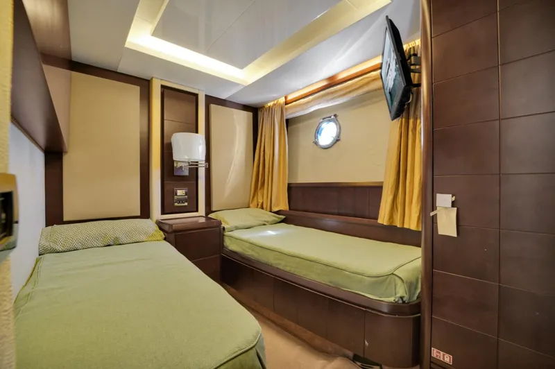 Slide: The Image of Luxurious twin cabin on 2009 Azimut 75 yacht with modern decor and porthole window. - 38