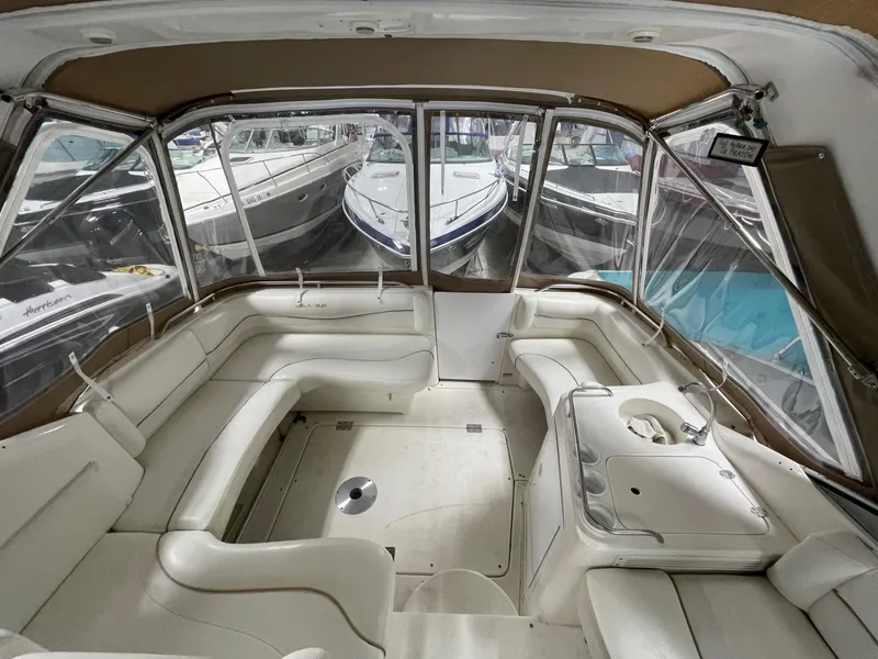 Slide: The Image of Interior of 1999 Larson 330 CABRIO boat with spacious seating and clear windows. - 10