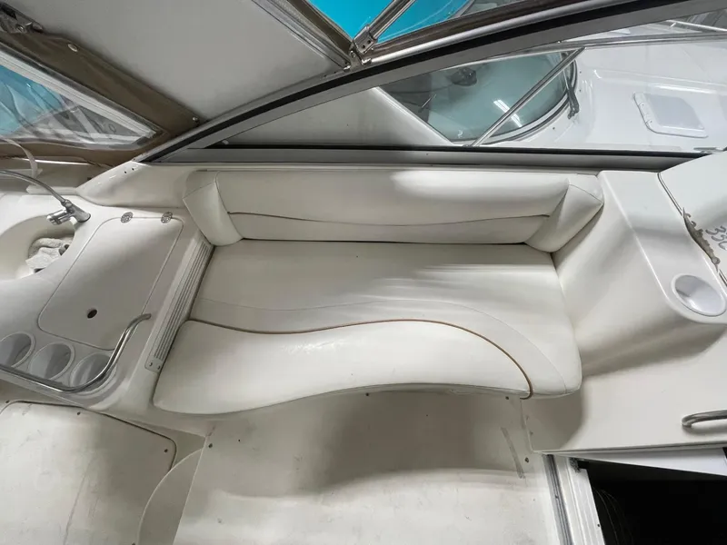 Slide: The Image of 1999 Larson 330 CABRIO boat interior with white seating and sleek design. - 11