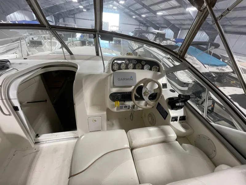 Slide: The Image of 1999 Larson 330 Cabrio boat interior with Garmin navigation system in a storage facility. - 12
