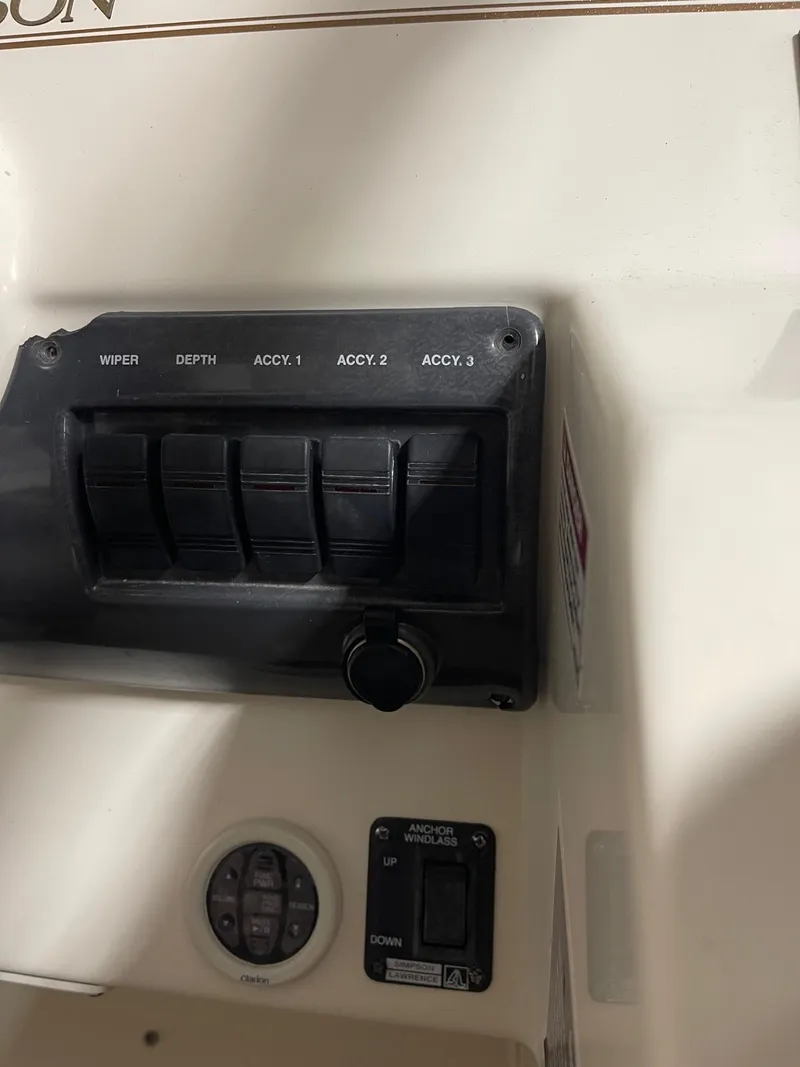 Slide: The Image of Control panel of 1999 Larson 330 Cabrio boat with labeled switches. - 16