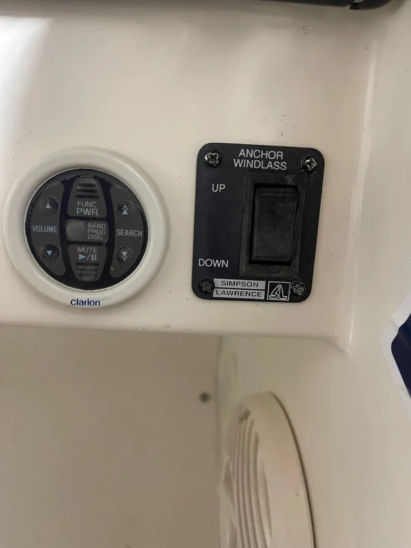 Slide: The Image of 1999 Larson 330 CABRIO boat controls, featuring Clarion audio and anchor windlass switches. - 17
