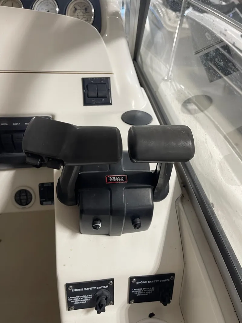 Slide: The Image of 1999 Larson 330 Cabrio boat throttle controls and dashboard. - 19