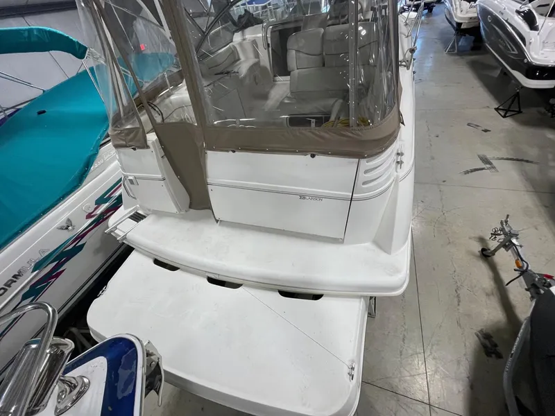 Slide: The Image of 1999 Larson 330 CABRIO boat in indoor storage, rear view. - 2