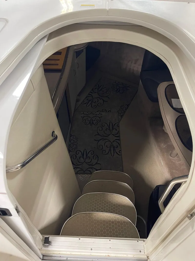 Slide: The Image of Interior view of 1999 Larson 330 CABRIO cabin with carpeted steps and floral rug. - 22