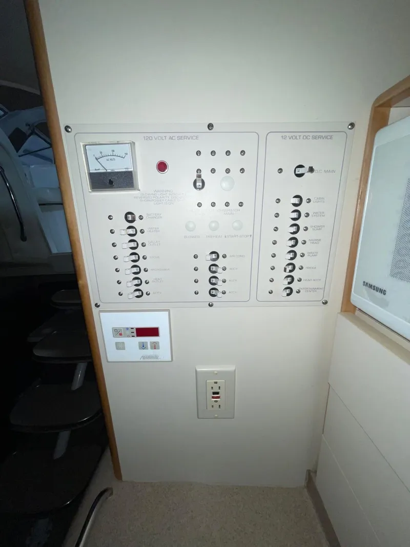 Slide: The Image of Electrical control panel inside 1999 Larson 330 CABRIO boat cabin. - 24