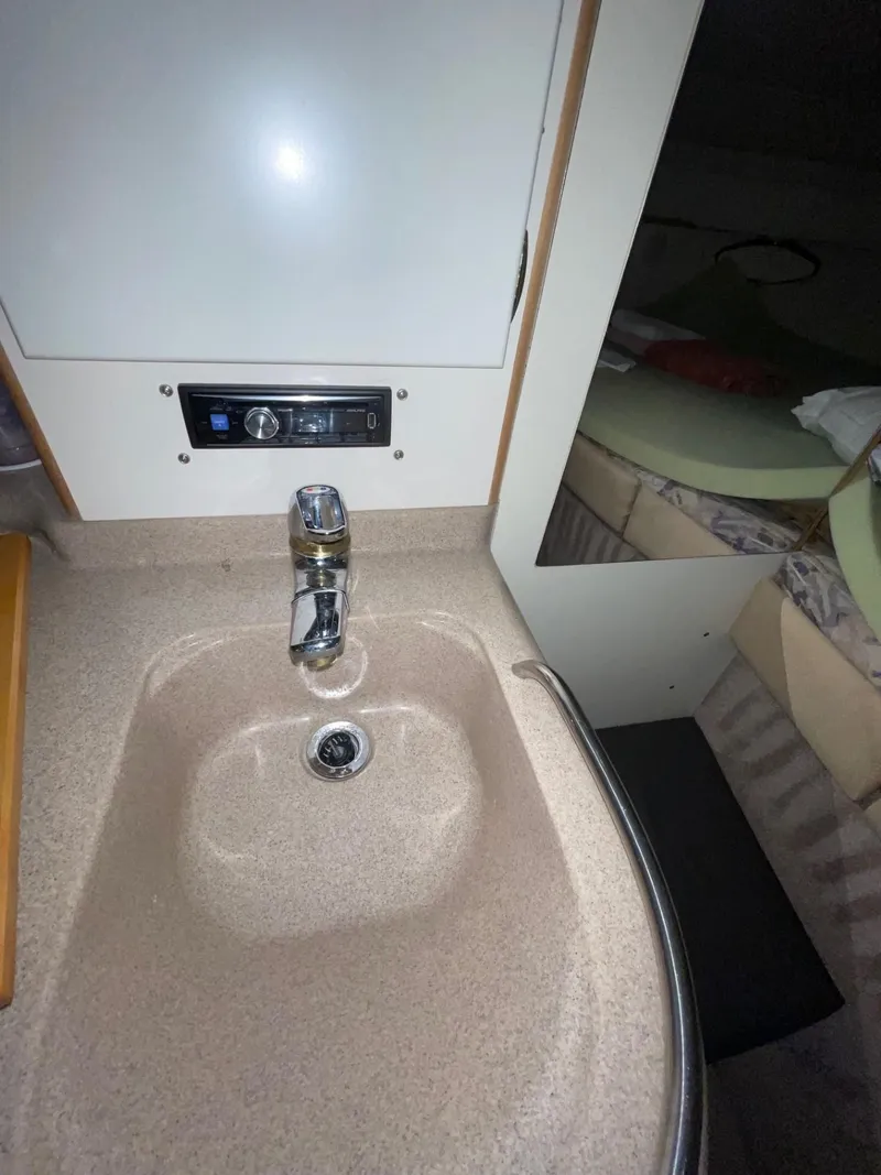 Slide: The Image of 1999 Larson 330 CABRIO boat interior with sink and faucet. - 27