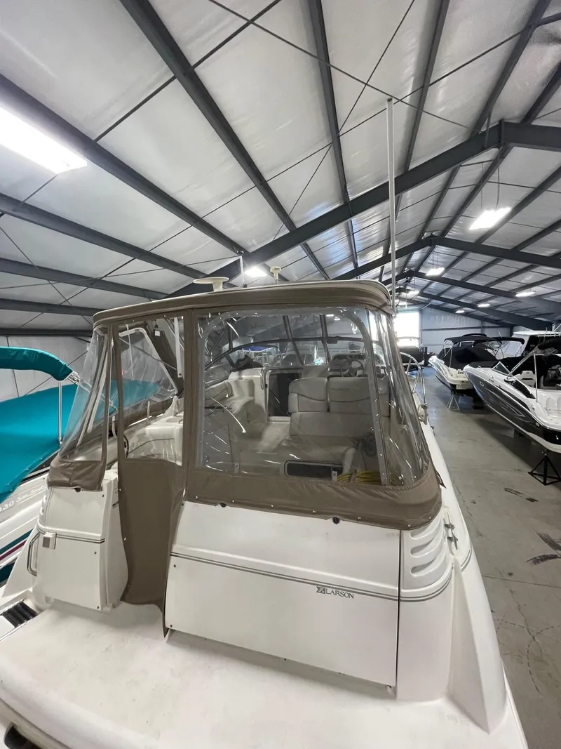 Slide: The Image of 1999 Larson 330 CABRIO boat in indoor storage facility. - 3