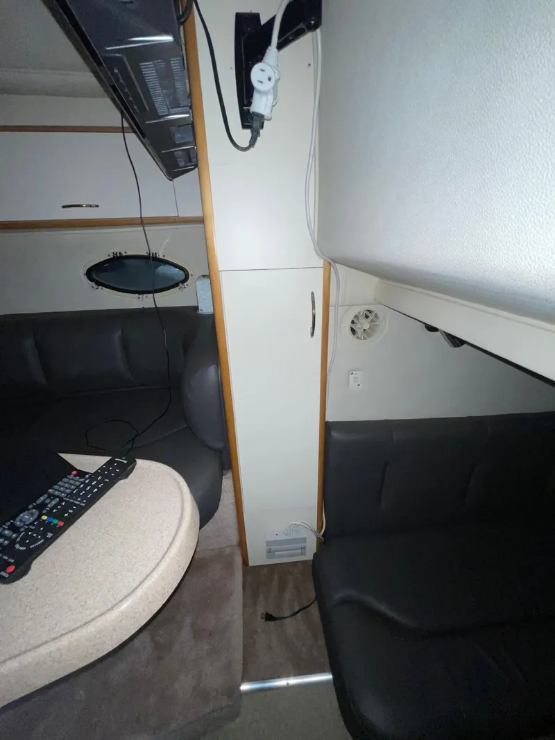 Slide: The Image of Interior of 1999 Larson 330 Cabrio boat with seating and control panel. - 31