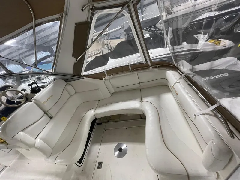 Slide: The Image of 1999 Larson 330 CABRIO boat interior with white leather seating. - 5