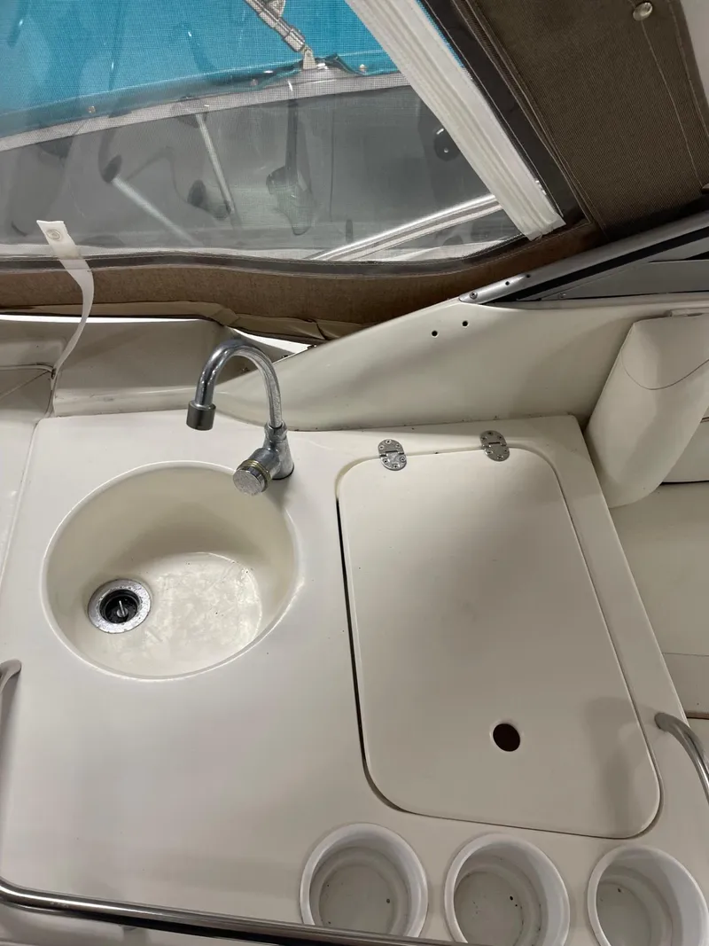 Slide: The Image of 1999 Larson 330 CABRIO boat interior with sink and counter. - 8