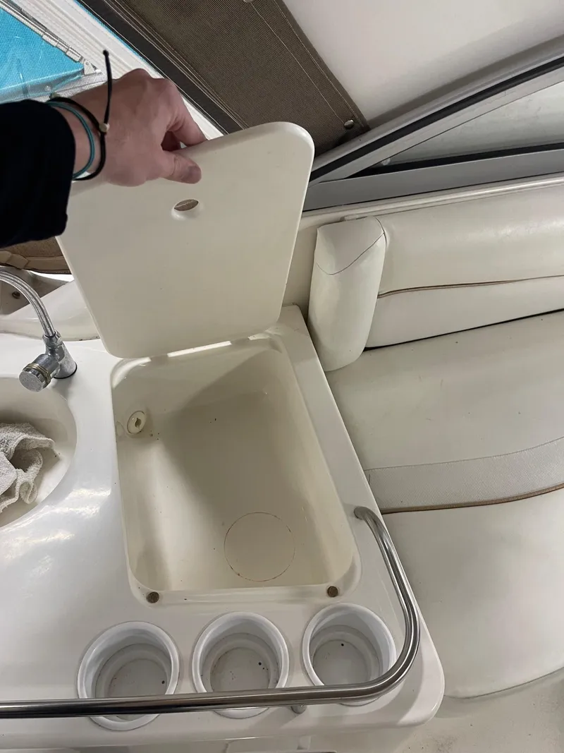 Slide: The Image of 1999 Larson 330 CABRIO boat interior with sink and storage compartment. - 9