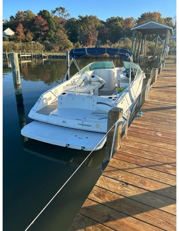 Slide: The Image of 2006 Rinker 296 Captiva Bowrider docked by wooden pier in scenic marina. - 3