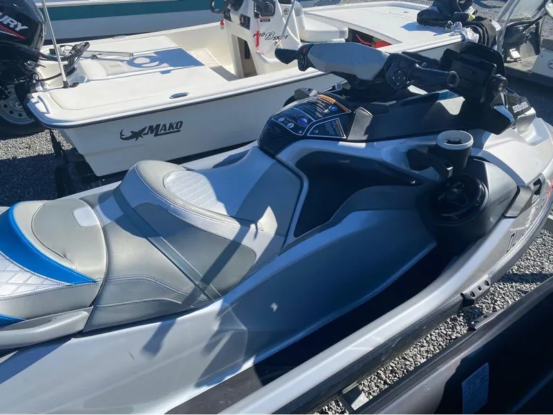 Slide: The Image of 2022 Sea-Doo GTX 300 jet ski with iBR and audio system, parked on gravel. - 3