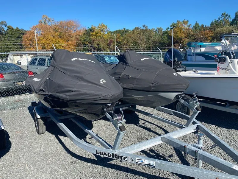 Slide: The Image of Pair of 2022 Sea-Doo GTX 300 jet skis on trailer, covered, in outdoor lot. - 5