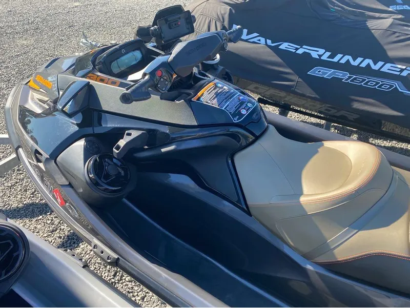 Slide: The Image of 2022 Sea-Doo GTX 300 jet ski with iBR and audio system, parked on gravel. - 6