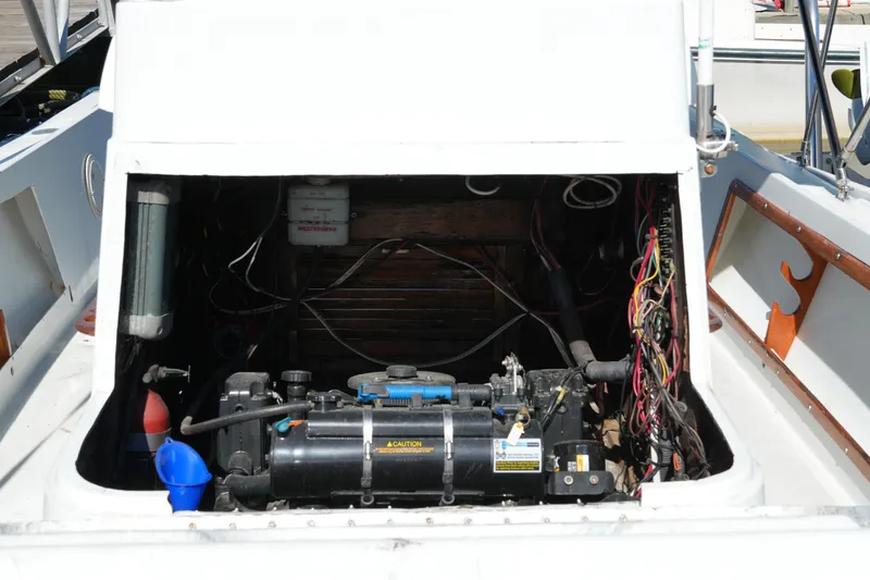 Slide: The Image of 1980 Mako 23 inboard engine compartment with visible wiring and components. - 14