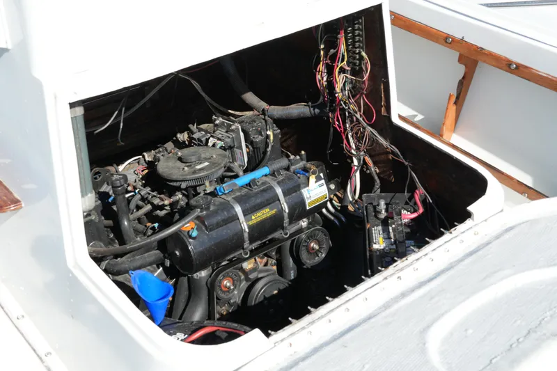 Slide: The Image of 1980 Mako 23 inboard engine compartment with visible wiring and components. - 15