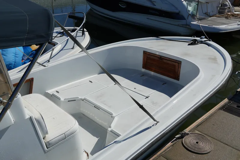 Slide: The Image of 1980 Mako 23 inboard boat with open deck, docked at marina. - 4