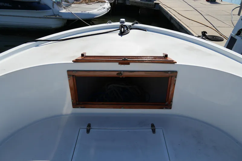 Slide: The Image of 1980 Mako 23 inboard boat deck with wooden hatch, docked at marina. - 9
